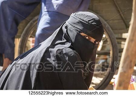 Stock Photograph - Eritrean woman in a Niqab at the open air market; Keren, Anseba Region, Eritrea. Fotosearch