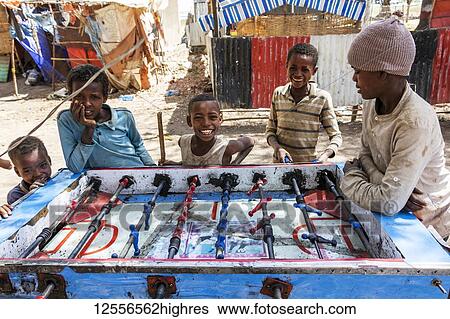 Stock Photograph - Ethiopian boys playing table football, Koka Reservoir (Lake Gelila); Oromia Region, Ethiopia. Fotosearch