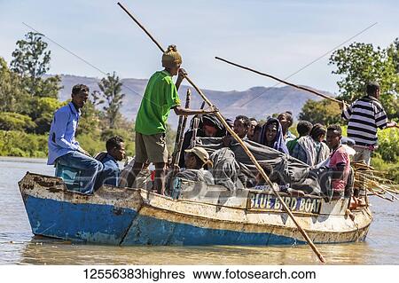 Stock Photograph - Ethiopian people on board a boat on the Blue Nile River; Amhara Region, Ethiopia. Fotosearch
