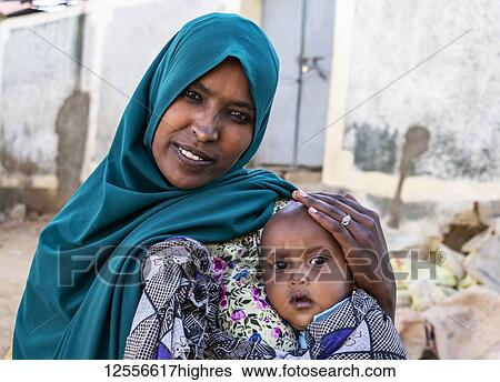 Ethiopian woman holding a boy in Harar Jugol, the Fortified Historic Town; Harar, Harari Region, Ethiopia View Large Photo Image Stock Photograph - Ethiopian woman holding a boy in Harar Jugol, the Fortified Historic Town; Harar, Harari Region, Ethiopia. Fotosearch