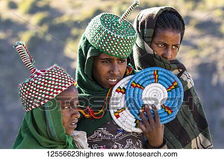 Stock Photograph - Ethiopian women selling placemats, Simien National Park; Amhara Region, Ethiopia. Fotosearch
