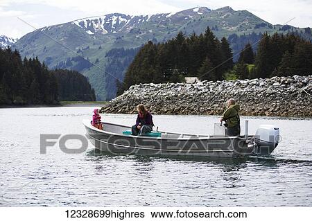 Stock Photograph - Family in their set-net skiff near Seldovia, South-central Alaska; Alaska, United States of America. Fotosearch