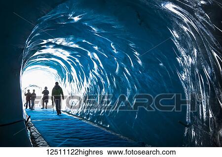 Family of tourists step into ice cave under Mer de Glace Glacier; Chamonix-Mont-Blanc, Haute-Savoie, France View Large Photo Image Stock Photograph - Family of tourists step into ice cave under Mer de Glace Glacier; Chamonix-Mont-Blanc, Haute-Savoie, France. Fotosearch
