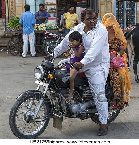 Stock Photograph - Family riding a motorcycle; Jaisalmer, Rajasthan, India. Fotosearch