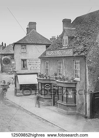 Stock Photograph - Faringdon village street scene including the famous Counsell Clock, magic lantern slide circa 1900; Faringdon, Oxfordshire, England. Fotosearch