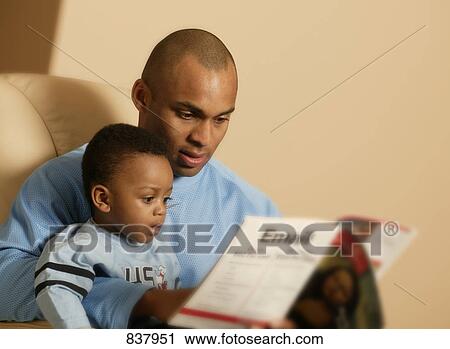 Stock Image - Father and son reading. Fotosearch