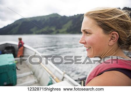 Female set-netter driving her set-net skiff near Seldovia, South-central Alaska; Alaska, United States of America View Large Photo Image Stock Photograph - Female set-netter driving her set-net skiff near Seldovia, South-central Alaska; Alaska, United States of America. Fotosearch