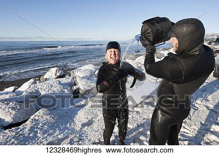 Female surfer rinsing off along Homer Spit Beach in winter, South-central Alaska; Homer Spit, Alaska, United States of America View Large Photo Image Stock Photograph - Female surfer rinsing off along Homer Spit Beach in winter, South-central Alaska; Homer Spit, Alaska, United States of America. Fotosearch