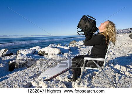 Female surfer rinsing off along Homer Spit Beach in winter, South-central Alaska; Homer Spit, Alaska, United States of America View Large Photo Image Stock Photograph - Female surfer rinsing off along Homer Spit Beach in winter, South-central Alaska; Homer Spit, Alaska, United States of America. Fotosearch