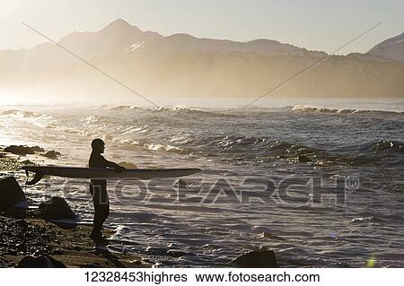 Female surfer standing along the wet shore of Kachemak Bay, South-central Alaska; Homer, Alaska, United States of America View Large Photo Image Stock Photograph - Female surfer standing along the wet shore of Kachemak Bay, South-central Alaska; Homer, Alaska, United States of America. Fotosearch