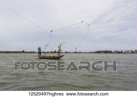 Fisherman throwing a net from a boat; Hoi An Ancient Town, Quang Nam, Vietnam View Large Photo Image Stock Photograph - Fisherman throwing a net from a boat; Hoi An Ancient Town, Quang Nam, Vietnam. Fotosearch