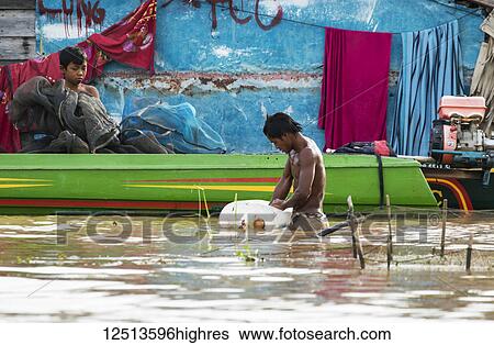 Fishermen and a boat on the Tonle Sap, Siem Reap, Cambodia View Large Photo Image Stock Photograph - Fishermen and a boat on the Tonle Sap, Siem Reap, Cambodia. Fotosearch