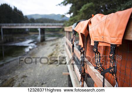 Stock Photograph - Fishing Bibs Hanging Over The Deck Rail, Seldovia, Southcentral Alaska, USA. Fotosearch