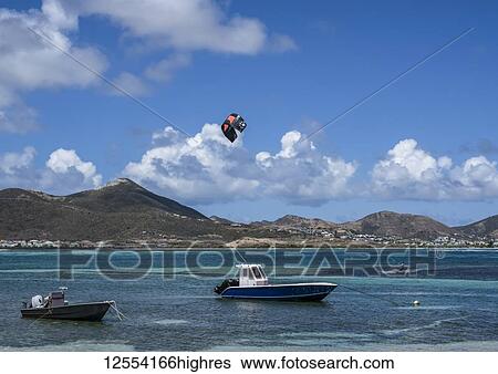 Stock Photograph - Fishing boats and windsurfer off coast of island of St Maarten; Marigot, Philipsburg, Sint Maarten. Fotosearch