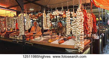 Stock Photograph - Fresh garlic hanging for sale in the Belgrade Green Market; Belgrade, Vojvodina, Serbia. Fotosearch