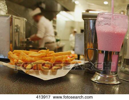 Fries with that shake View Large Photo Image Stock Photo - Fries with that shake. Fotosearch