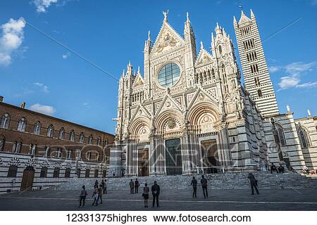 Stock Photograph - Front Facade Of The Ancient White And Red Marble Siena Cathedral; Siena, Italy. Fotosearch