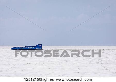 Stock Photograph - Fuel Streamliner Class AA/FS 1968 Thompson Streamliner at speed at 406. 769 mph record attempt on Bonneville Salt Flats during Bonneville Speed Week 2017; Wendover, Utah, United States of America. Fotosearch
