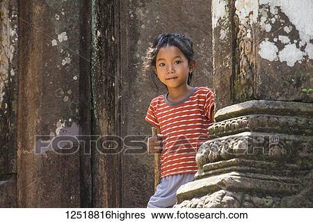 Stock Photograph - Girl at the North Quadrangle, Vat Phou Temple Complex; Champasak, Laos. Fotosearch