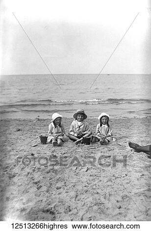 Glass Negative circa 1900. Victorian. Social History. Children sitting on the beach View Large Photo Image Stock Photograph - Glass Negative circa 1900. Victorian. Social History. Children sitting on the beach. Fotosearch