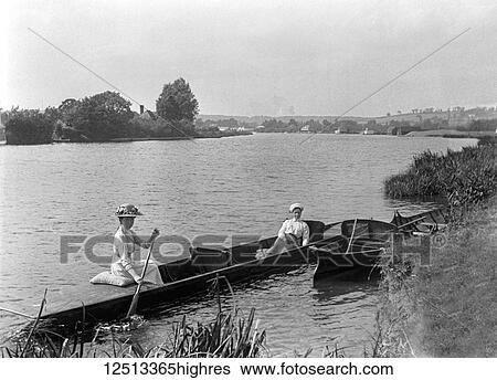 Stock Photograph - Glass Negative circa 1900. Victorian. Social History. Two ladies in rowing boat on river Thames. Fotosearch