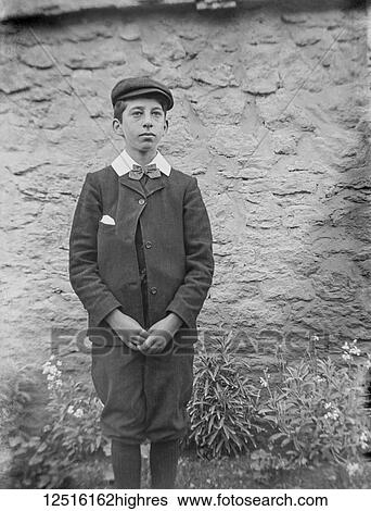 Stock Photograph - Glass Negative circa 1900. Victorian. Social History. An Edwardian or Victorian young man posing for a photograph. Fotosearch