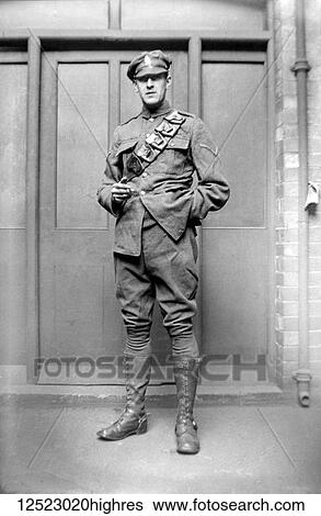 Stock Photograph - Glass Negative circa 1900. Victorian. Social History. A Military Transport Driver with bandoliersmoking a cigarette.. Fotosearch