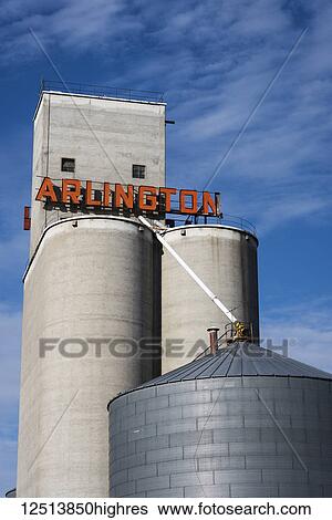 Stock Photograph - Grain elevator and silo with sign for Arlington; Arlington, Oregon, United States of America. Fotosearch