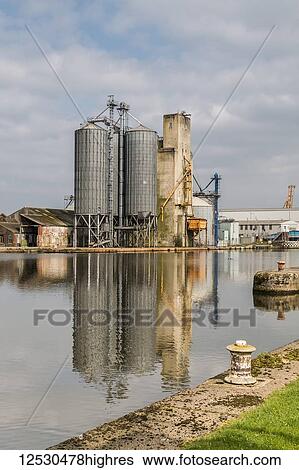 Grain silos at the edge of an inland dock; Yorkshire, England View Large Photo Image Stock Photograph - Grain silos at the edge of an inland dock; Yorkshire, England. Fotosearch