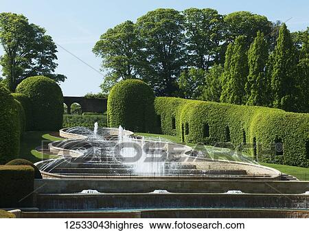 Stock Photograph - Grand Cascade performing in The Alnwick Garden; 0rthumberland, England. Fotosearch