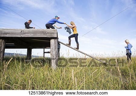Group of young adults exploring coastal Homer, South-central Alaska; Homer, Alaska, United States of America View Large Photo Image Stock Photograph - Group of young adults exploring coastal Homer, South-central Alaska; Homer, Alaska, United States of America. Fotosearch