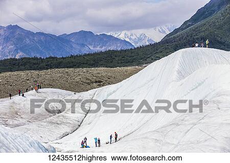 Stock Photograph - Guided groups recreate on Root Glacier in Wrangell-St. Elias National Park; Alaska, United States of America. Fotosearch