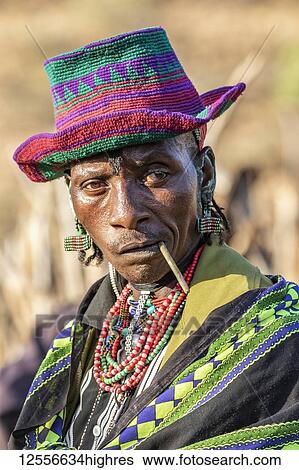 Stock Photograph - Hamer man wearing a colourful hat at a bull jumping ceremony, which initiates a boy into manhood, in the village of Asile, Omo Valley, Ethiopia. Fotosearch