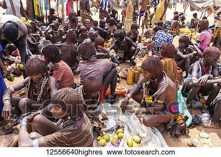 Stock Photograph - Hamer women at the weekly market in Turmi, Omo Valley; Turmi, Southern Nations Nationalities and Peoples' Region, Ethiopia. Fotosearch