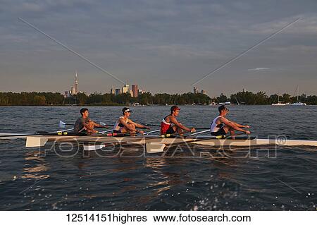 Stock Photograph - Hanlan Boat Club Junior men at morning practice in Lake Ontario; Toronto, Ontario, Canada. Fotosearch