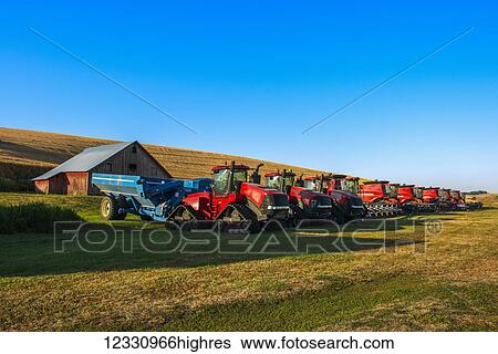 Stock Photograph - Harvesting Equipment Lined Up Ready To Begin The Harvest Day In The Palouse Region Of Eastern Washington; Washington, United States Of America. Fotosearch