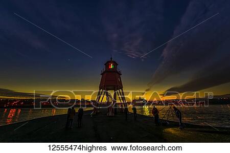 Stock Photograph - Herd Groyne Lighthouse and dramatic sunset; South Shields, Tyne and Wear, England. Fotosearch