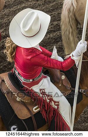 High angle view of a woman wearing a white cowboy hat and riding a horse at the Calgary Stampede; Calgary, Alberta, Canada View Large Photo Image Stock Photograph - High angle view of a woman wearing a white cowboy hat and riding a horse at the Calgary Stampede; Calgary, Alberta, Canada. Fotosearch