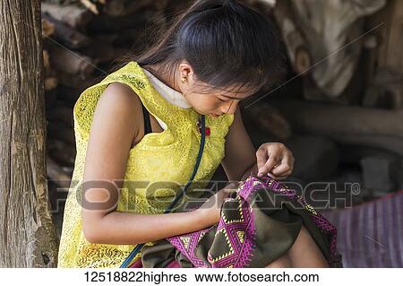Stock Photograph - Hmong woman making embroideries, Na Aouan Village; Luang Prabang, Laos. Fotosearch