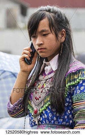 Hmong woman talking on a mobile phone at the Sunday market; Bac Ha, Lao Cai, Vietnam View Large Photo Image Stock Photograph - Hmong woman talking on a mobile phone at the Sunday market; Bac Ha, Lao Cai, Vietnam. Fotosearch
