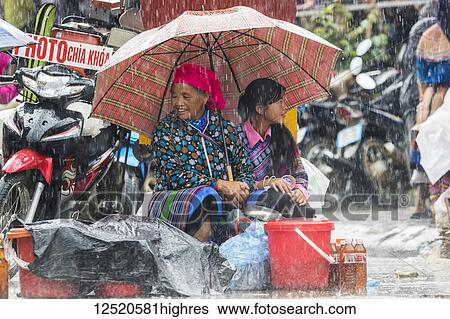 Hmong women at the Sunday market in the rain; Bac Ha, Lao Cai, Vietnam View Large Photo Image Stock Photograph - Hmong women at the Sunday market in the rain; Bac Ha, Lao Cai, Vietnam. Fotosearch