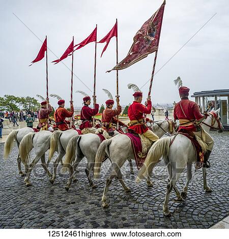 Horsemen dressed in red carrying flags at Buda Castle in Buda's Castle District; Budapest, Budapest, Hungary View Large Photo Image Stock Photograph - Horsemen dressed in red carrying flags at Buda Castle in Buda's Castle District; Budapest, Budapest, Hungary. Fotosearch