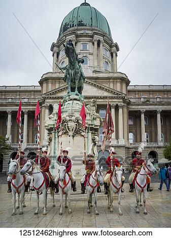 Horsemen dressed in red carrying flags at Buda Castle in Buda's Castle District; Budapest, Budapest, Hungary View Large Photo Image Stock Photograph - Horsemen dressed in red carrying flags at Buda Castle in Buda's Castle District; Budapest, Budapest, Hungary. Fotosearch
