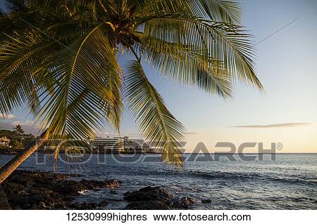 Stock Photograph - Hotel along Alii Drive, Kailua Bay; Kailua-Kona, Island of Hawaii, Hawaii, United States of America. Fotosearch
