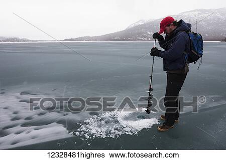 Hunter bores hole for a seal hunt, Lake Iliamna, Pedro Bay, South-central Alaska; Alaska, United States of America View Large Photo Image Stock Photograph - Hunter bores hole for a seal hunt, Lake Iliamna, Pedro Bay, South-central Alaska; Alaska, United States of America. Fotosearch