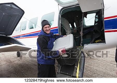 Hunter packing gear and supplies into a bag in preparation for a freshwater harbor seal hunt; Alaska, United States of America View Large Photo Image Stock Photograph - Hunter packing gear and supplies into a bag in preparation for a freshwater harbor seal hunt; Alaska, United States of America. Fotosearch