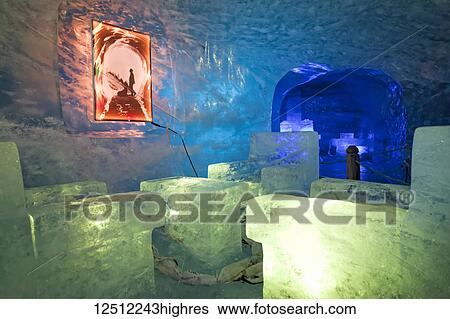 Stock Photograph - Ice sculptures light up in ice cave under Mer de Glace Glacier; Chamonix-Mont-Blanc, Haute-Savoie, France. Fotosearch