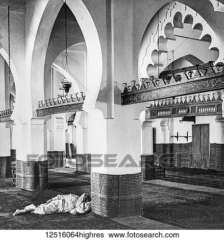Stock Photograph - Interior of the Great Mosque of Algiers, Djamaa el Kebir, and a man sleeping on the floor; Algiers, Algeria. Fotosearch
