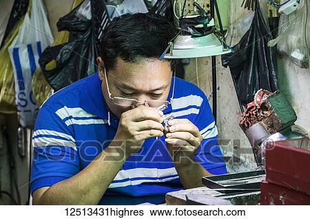 Jeweler at the Central Market Hall; Phnom Penh, Cambodia View Large Photo Image Stock Photograph - Jeweler at the Central Market Hall; Phnom Penh, Cambodia. Fotosearch