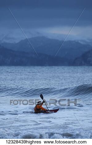 Kayak surfer approaching a wave in Kachemak Bay, Southcentral Alaska; Homer, Alaska, United States of America View Large Photo Image Stock Photograph - Kayak surfer approaching a wave in Kachemak Bay, Southcentral Alaska; Homer, Alaska, United States of America. Fotosearch